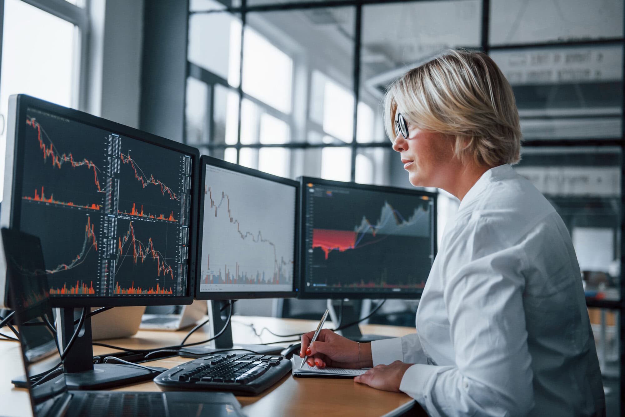 Female stockbroker in formal clothes works in the office with financial market Frequent changes to my portfolio