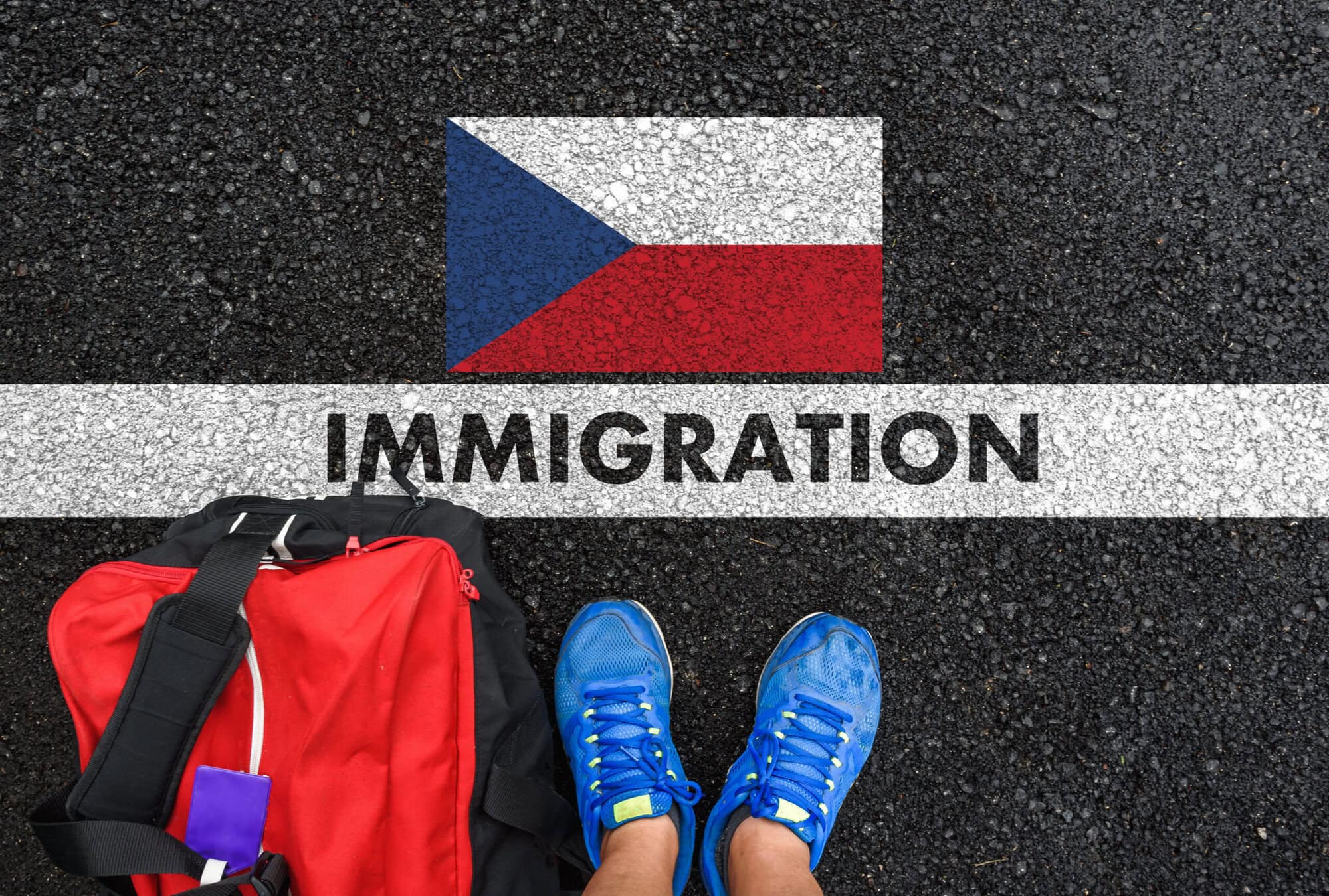 Man in shoes with bag standing next to line with word IMMIGRATION and flag of Czech Republic on asphalt road Moving to the Czech Republic requires getting a visa.