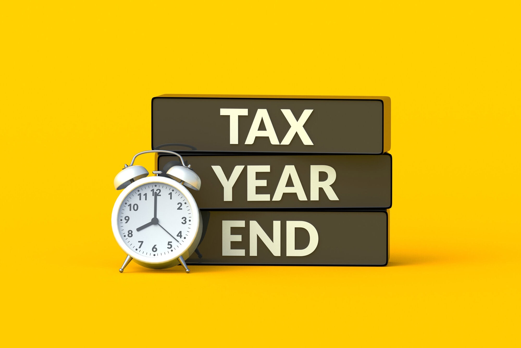 Tax year end words on blocks near alarm clock. Annual payment reminder. Violation of reporting rules. Deadline for filing the report. Countdown to the issuance of a fine. 3d render Investment tax exemption